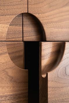 a close up of a wooden object with holes in the center and an opening at the end