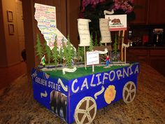 a cake made to look like a carton with california on it and trees in the background