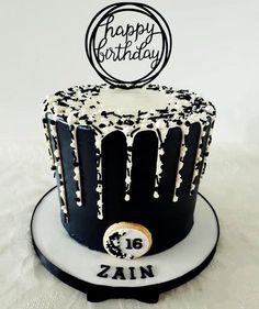 a black and white birthday cake decorated with icing