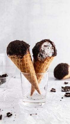 two ice cream cones with chocolate chips in them