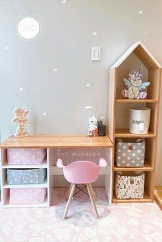 a doll house desk with pink chair and toy storage bins on the bottom shelf