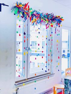 colorful streamers are hanging from the windows in an office