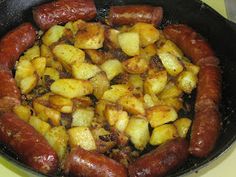 sausage and potatoes cooking in a skillet