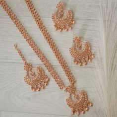 This Beautiful Rose Gold Polki Stone Long Mala Necklace Rani Haar Set for all Vibrant colors for your special events.    Set Includes: Necklace, Tikka and Chandbali Earrings  Dimension:- necklace:- Length 12"  Earrings:- Drop Length 2.5"  Approximately. Festive Rose Gold Bridal Necklace For Wedding, Rose Gold Bridal Necklace For Party, Traditional Rose Gold Necklace For Party, Traditional Rose Gold Party Necklace, Traditional Rose Gold Wedding Necklace, Festive Rose Gold Bridal Necklace, Rani Haar, Ear Chain, Chandbali Earrings