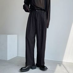 Make a powerful statement with our Pleated Wide Leg Trousers featuring bold vertical stripes - an essential for the fashion-forward individual. Crafted with meticulous attention to detail, these trousers boast a relaxed fit through the hips and thighs, gracefully flaring into a wide-leg silhouette. The pleated design and vertical stripe pattern not only elongate the legs but also add a touch of sophistication, making them ideal for a variety of occasions and styles.The versatility of these trous Trendy Striped Pants For Work, Wide Leg Ankle-length Pants With Vertical Stripes For Spring, Spring Wide Leg Pants With Vertical Stripes, Ankle-length, Spring Ankle-length Wide Leg Pants With Vertical Stripes, Trendy Vertical Stripes Pants For Workwear, Trendy Vertical Stripes Pants For Work, Trendy Workwear Bottoms With Vertical Stripes, Casual Striped Wide Leg Work Pants, Casual Striped Wide Leg Pants For Work