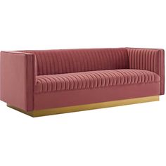 a pink couch with gold trim on the arm and back, in front of a white background