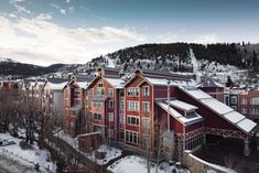 a red building surrounded by snow covered mountains