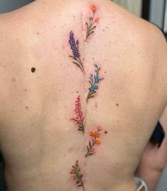 a woman's back with flowers on it