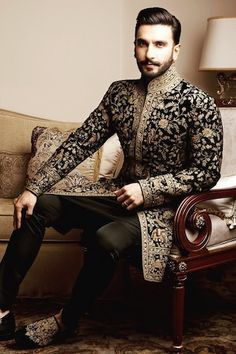 a man sitting on top of a couch in a living room