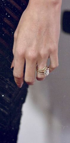 a close up of a person's hand with a ring on it