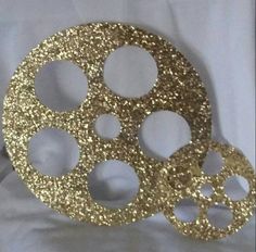 gold glittered film reel on white background