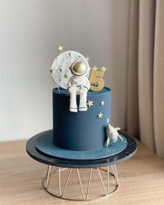 a blue cake with an astronaut on top