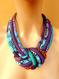 "African Purple knot fabric necklace that I made from bold and vibrant, purple African wax fabrics mixture. To finish it I have added a copper color magnetic clasp for easy handling. If you want to add that colorful and chic touch to your outfit than this necklace can turn your look to fabulous. Length from one end to the other in a straight line is 19 inches inches or 48 cm. Please let me know if you want changes on the length. Care: This is a fabric necklace so a minimum care should be taken e Tribe Necklace, Light Weight Necklace, Fabric Jewellery, African Necklace, Bold Necklace, Jewelry Knots, Denim Wear, Fabric Necklace