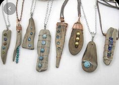 five necklaces with different designs and colors on them