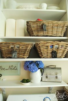 the shelves are filled with baskets, towels and other things to put on top of them