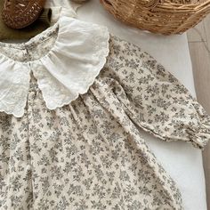 Discover the grace and elegance of our Cotton Floral Dress. Made from light cotton, this luxurious dress features long sleeves and a ruffled embroidered collar. The delicate floral print adds a touch of sophistication, making it the perfect choice for your little girl's special occasion attire. This dress runs big, we advise you to size down. Cream Long Sleeve Dress With Lace Collar, Long Sleeve Dresses With Lace Collar For Garden Party, Long Sleeve Cottagecore Dress With Lace Trim, White Cotton Dress With Ruffled Collar, Cotton Dress With Ruffled Collar For Garden Party, Spring Long Sleeve Dress With Lace Collar, Cotton Dresses With Lace Trim And Ruffled Collar, Spring Cream Dress With Peter Pan Collar, Long Sleeve Dresses With Lace Collar In Cottagecore Style