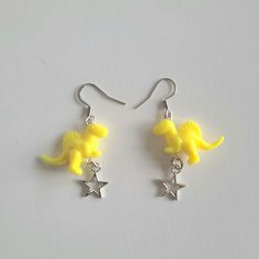 Yellow Dinosaur Earrings With Silver Star Charms. Made With Acrylic Beads. Nickel Free Findings. Brand New Condition. Ships Next Business Day Offers Are Welcome Trendy Jewelry 90s 2000s Unisex Festival Indie Gender Neutral Boho Bohemian Streetwear Urban Casual Gift For Her Or Him Birthday Present Quirky Alt Novelty Funky Hoop Earrings, Fun Jewelry Aesthetic, Gay Earrings, Alt Earrings, Bohemian Streetwear, Silly Earrings, Jewelry 90s, Yellow Dinosaur, Dinosaur Jewelry