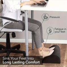 a woman sitting at a desk with her feet up on the computer chair and typing