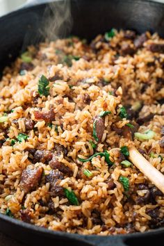 a skillet filled with rice and meat