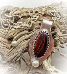 This one of a kind Sterling pendant features a rich brown tiger iron gemstone with a luminous cultured pearl accent. I am reminded of Hot Fudge Sundaes when I see this pendant. the richness of deep brown tiger iron with a pearly whipped cream topping. Plus there are NO CALORIES in this sundae! A textured sterling neck chain is included. Pendant is 2 1/2" high. Tiger Iron Gemstone is 1 1/2" high. neck chain is 20" and can be adjusted down to your preference. Features a sterling silver clasp. Free Brown Pearl Pendant Jewelry Gift, Brown Pearl Pendant Necklace Gift, Brown Pearl Pendant Necklace For Gift, Brown Pearl Pendant Necklace As Gift, Gift Brown Pearl Pendant Necklace, Whipped Cream Topping, Tiger Iron, Brown Tiger, Hot Fudge