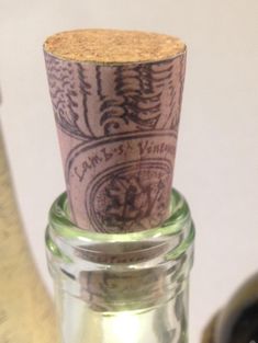 a bottle with a cork top sitting on a table