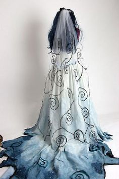 the back of a woman's dress with blue and white swirls on it