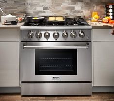 a stove top oven sitting inside of a kitchen