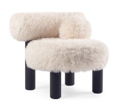 a white chair with black legs and fur on it