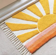 a yellow and white rug with the sun on it