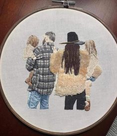 a cross stitched picture of three people standing in front of each other with one person wearing a hat