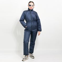 "Vintage one piece ski jumpsuit in navy blue - two outer pockets - lined and insulated - material: shell and  lining - 100% nylon; padding - polyester SIZE size from label: 42 best fits women: L/XL MEASUREMENTS bust: 42.5 inches (108 cm) hips: 41 inches (104 cm) length: 57.5 inches (146 cm) inseam: 30 inches (76 cm) sleeve length from the neck: 29.5 inches (75 cm) The model is 5'9\" (174 cm), measures 35-27-38 (89-69-96 cm) and typically wears clothing in size M CONDITION - 8/10 - The jumpsuit in good pre-owned vintage condition. Washed, ready to wear." Winter Jumpsuits And Rompers With Pockets, Vintage Ski Suits For Women, Snow Jumpsuit, Perfect Moment Ski Suit, Asos Ski Suit, Cordova Ski Suit, Ski Jumpsuit, Ski Vintage, Ski Suits