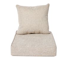 a beige pillow sitting on top of a white chair with a tan back and seat cushion