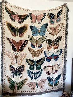 a wall hanging with many different butterflies on it