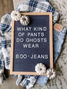 a sign that says what kind of pants do ghosts wear boo - jeans on the floor