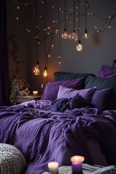 a bed with purple linens and lights hanging from the ceiling