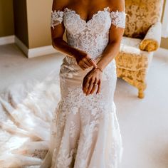 a woman in a wedding dress is posing for the camera with her hand on her hip