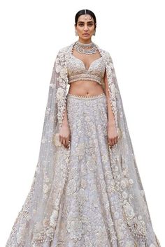 Ivory attached cancan lehenga with thread, pearl, sequin, bead embroidery in 3D floral pattern. Paired with half sleeve embroidered padded blouse and dupatta. - Aza Fashions Wedding Choli With Lace Work For Festivals, Wedding Lehenga With Lace Work For Diwali, Fitted Lehenga With Pearl Embroidery, Luxury Pearl Embroidered Lehenga For Festivals, Floor-length Pearl Embroidered Lehenga, White Hand Embellished Semi-stitched Lehenga, Luxury Pearl Embroidered Lehenga, Floral Bridal Lehenga, Seema Gujral