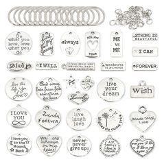 a bunch of metal tags and charms on a white background with words that say i love you