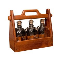 four glass bottles in a wooden holder