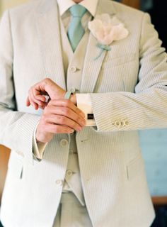 two men in suits and pink ties one is wearing a boutonniere