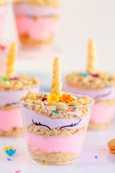 unicorn desserts in small cups with candy and sprinkles on them,