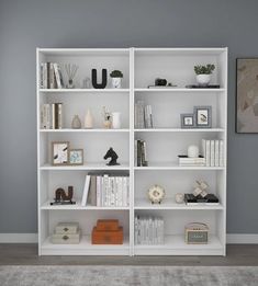 a white bookcase with many books on it