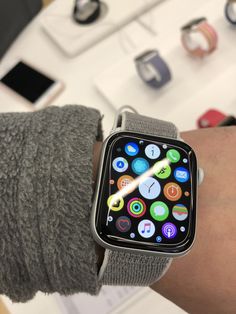 an apple watch on someone's wrist with various app icons in the display screen