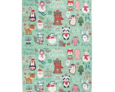 a green christmas towel with animals and snowflakes on the front, along with words that read merry christmas