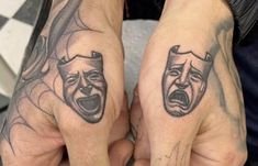 two people with tattoos on their hands holding each other's hands and screaming faces