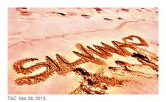 the word summer written in sand on a beach