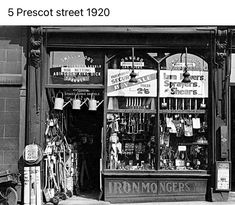 an old black and white photo of a store front