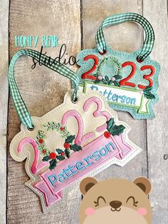 two personalized tags with a teddy bear on one side and the number twenty two in the other