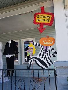 a couple of halloween decorations on the front porch