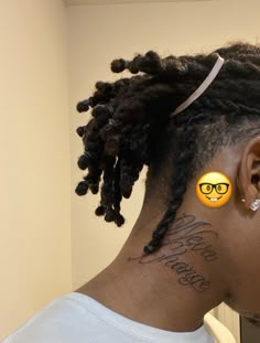 a woman with glasses has her hair up and is wearing some stickers on her ear